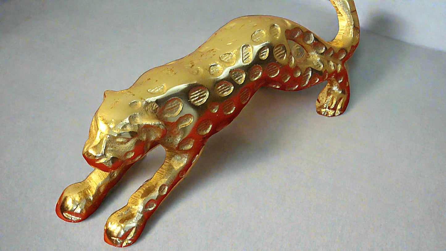 Gold panther figurine on a light gray background