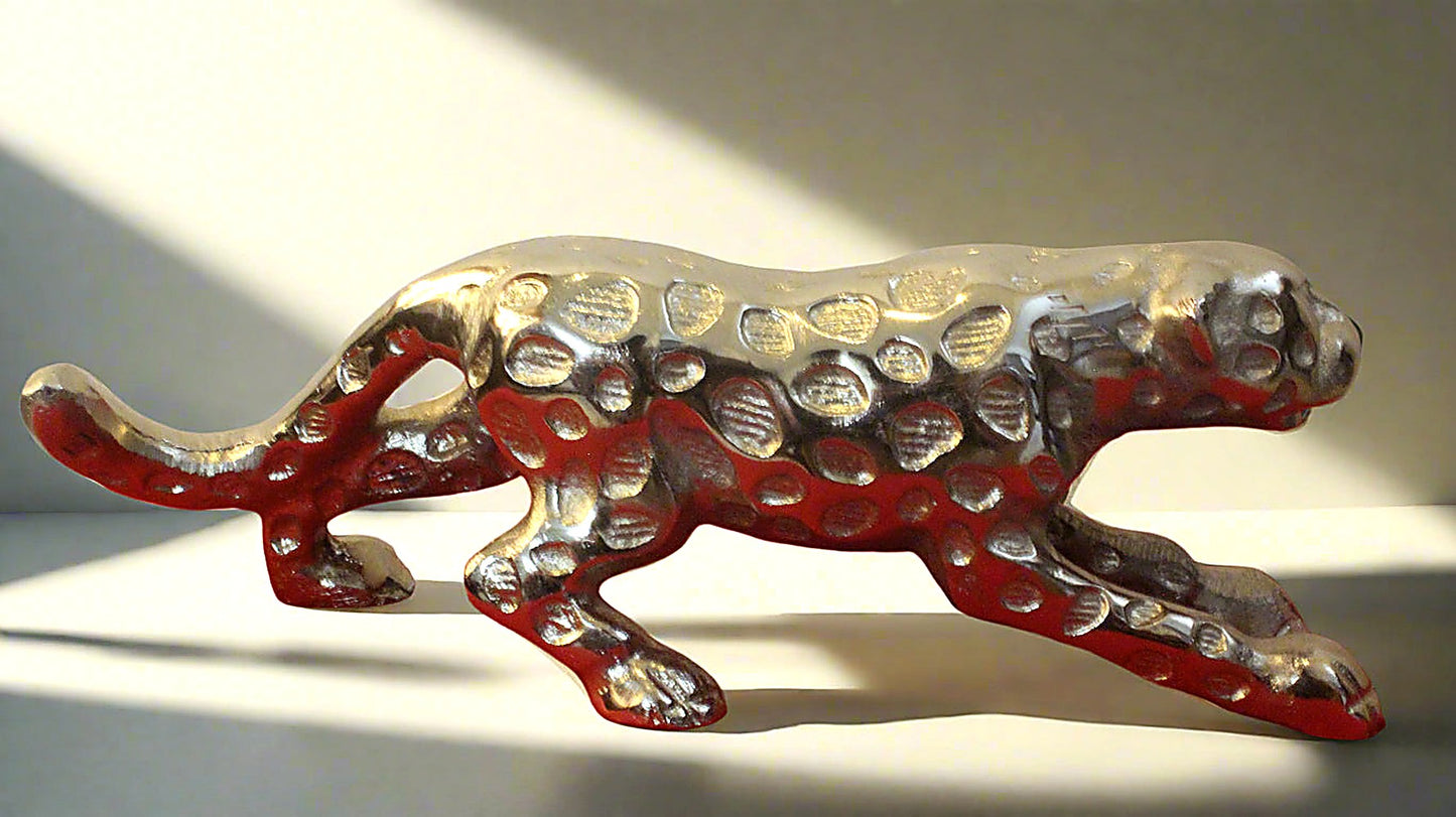 Decorative figurine of a panther with red and silver design on a white background