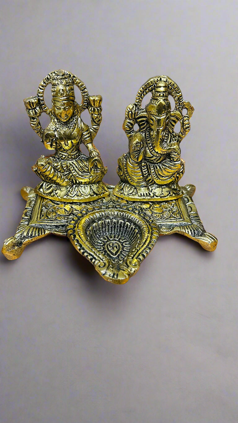Decorative brass statue of two figures on a gray background