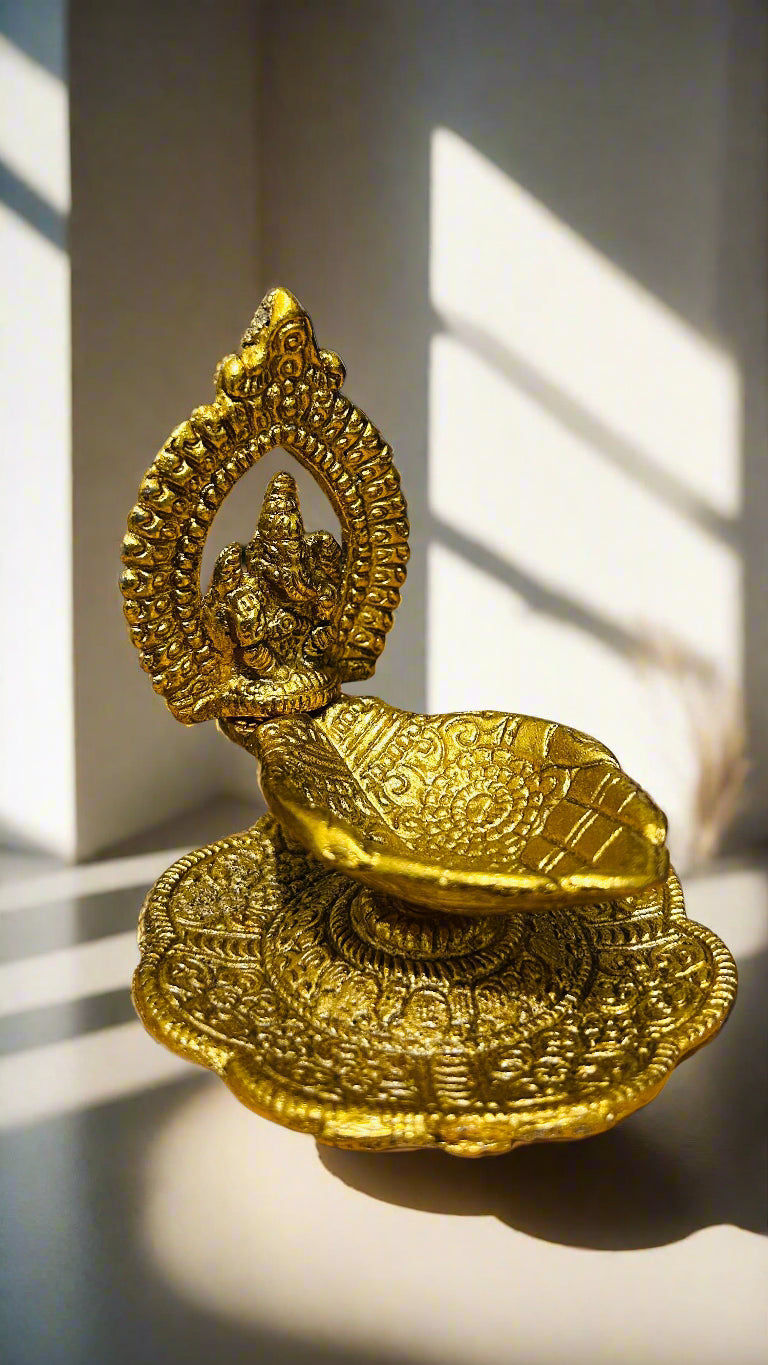 Gold decorative item on a wooden surface with a blurred background