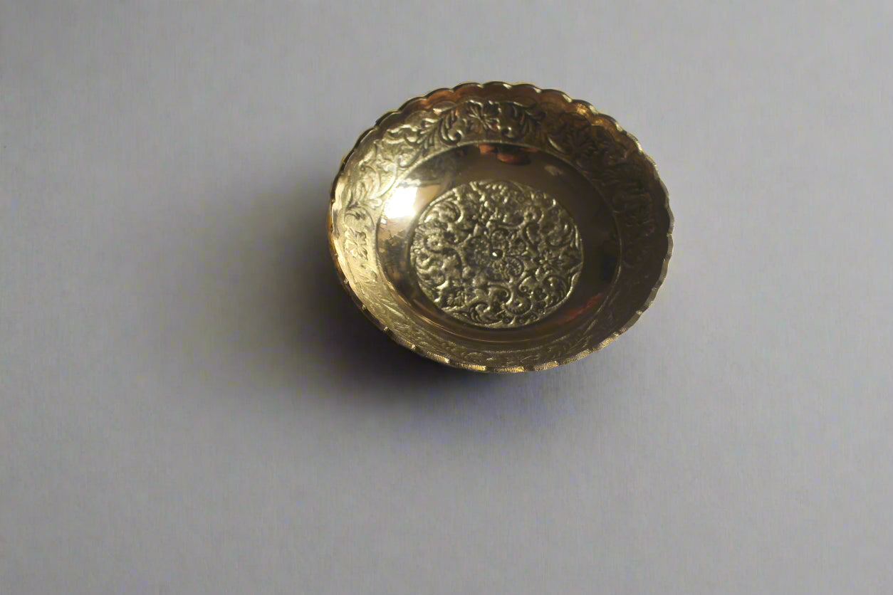 Decorative gold object on a light-colored surface