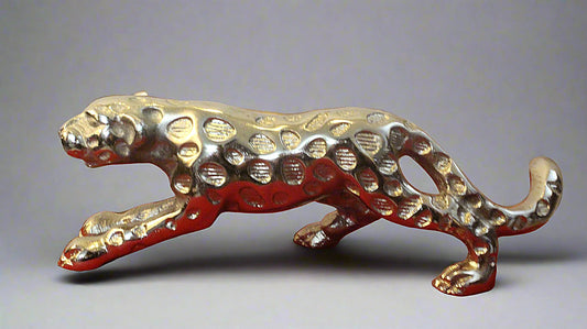 Metallic panther figurine on a gray background