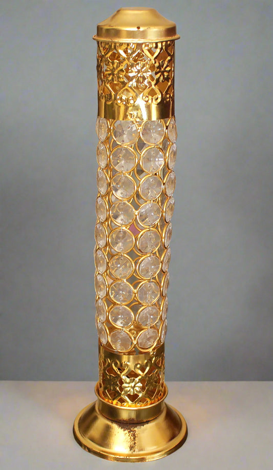 Decorative gold lamp with textured design on a gray background