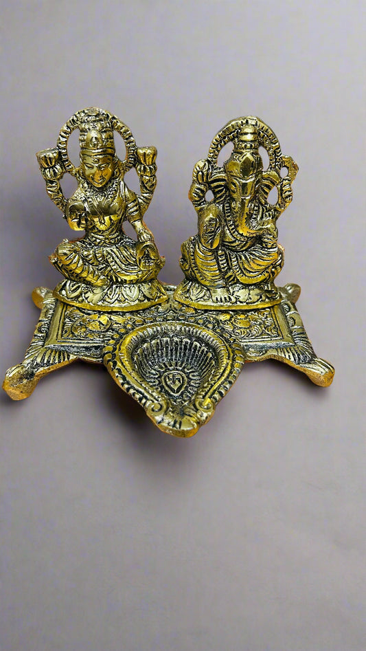 Decorative brass statue of two figures on a gray background